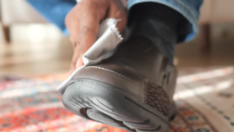 man cleaning his leather shoes