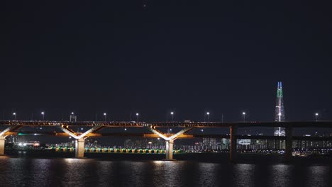 cheongdam bridge at night crossing han river with lotte tower in background