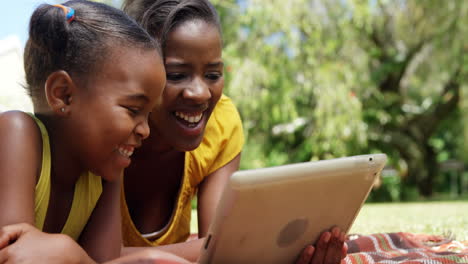 Porträt-Einer-Süßen-Mutter-Und-Tochter,-Die-Im-Garten-Ein-Tablet-Verwenden-