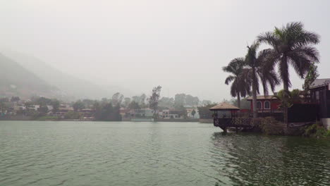 static shot of la molina, lima, peru with residential houses along lakeside on a cloudy day