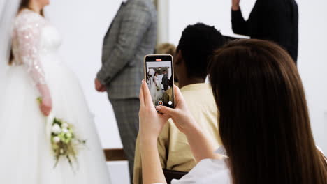 guest using smartphone at the ceremony