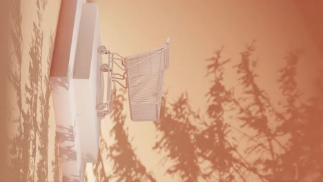 empty shopping cart on a yellow platform with shadow of branches on a yellow background