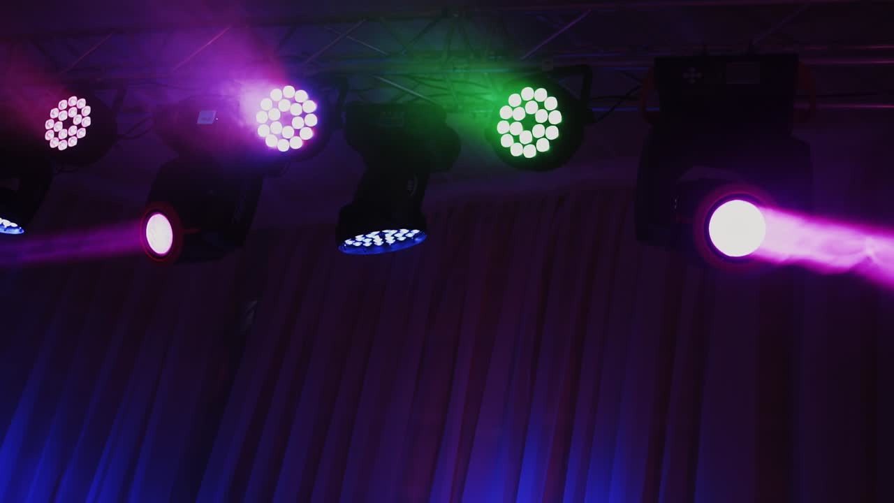 Stage light rack with colorful spotlights. Musical farm with lasers rotating and shining down in the concert hall.