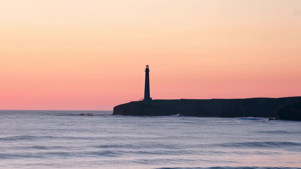 Tall lighthouse silhouette stands on rugged cliff above gentle surf, with pastel sunset colors washing wide sky and calm sea below in quiet remote coastal landscape with soft evening mood