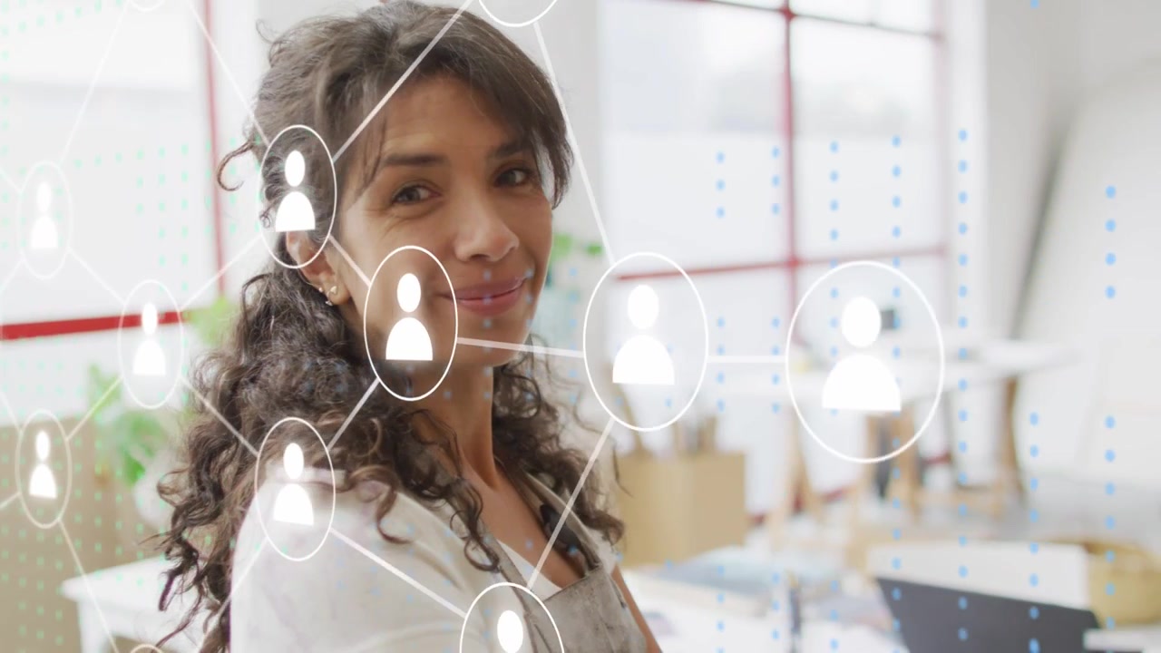 Artist woman standing in studio, UI icons appearing and forming network over her, linking artwork