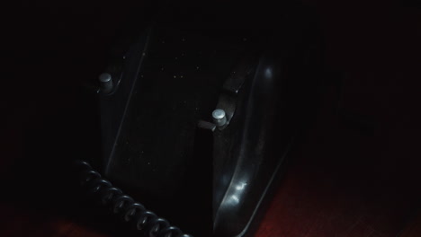 person nervously presses the button on the crank phone