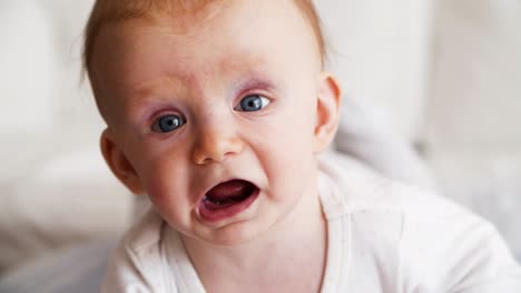 closeup of positive smiling baby trying to crawl