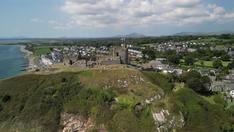 stunning criccieth castle on a lovely summer afternoon - aerial drone pan left and rotate from far - north wales, uk