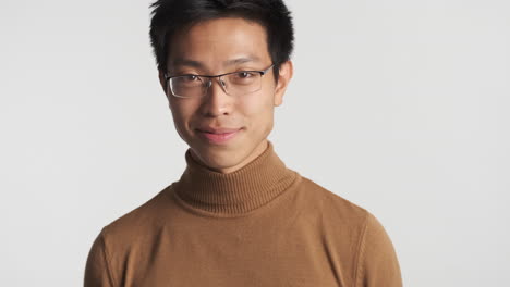 asian man in eyeglasses looking at the camera.