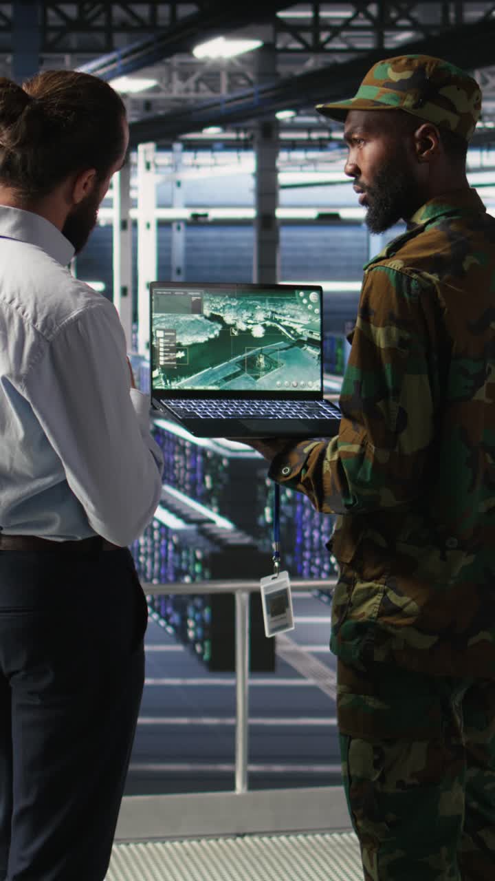 Vertical video Military IT specialists in server hub using scanner tools to oversee battlefield