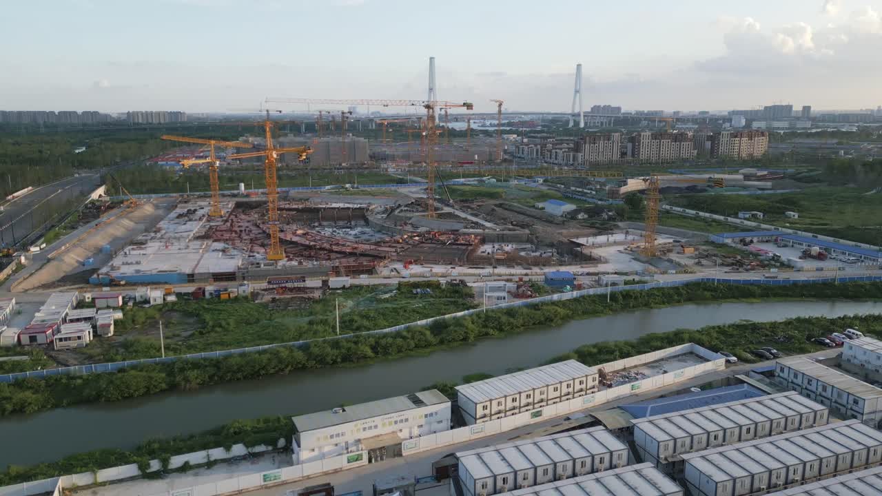 Aerial view of Cranes and Constuction site next to a Chinese river in Shanghai