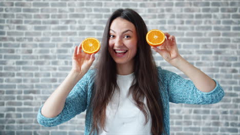 woman holding orange slices