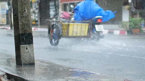 4k video pov to the local road in phuket city while heavy raining in the rainy season. crossing road in raining time