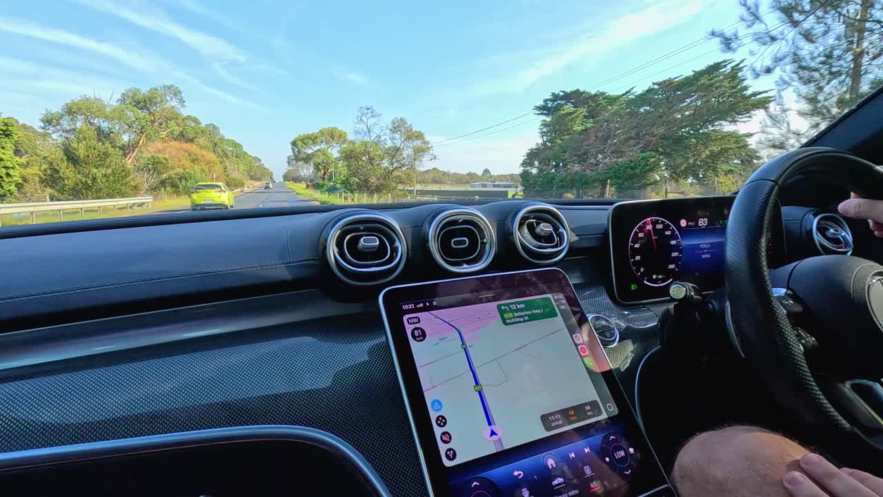 A car journey through Point Lonsdale, Australia, showcasing lush landscapes and clear skies. Interior car view with navigation screen visible