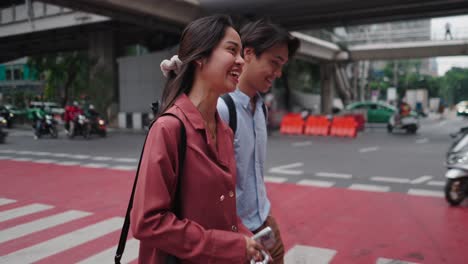 couple walking across a city crosswalk