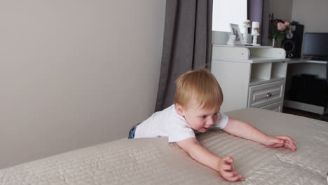 The-boy-is-standing-in-front-of-the-parents'-bed-and-having-fun-with-their-parents