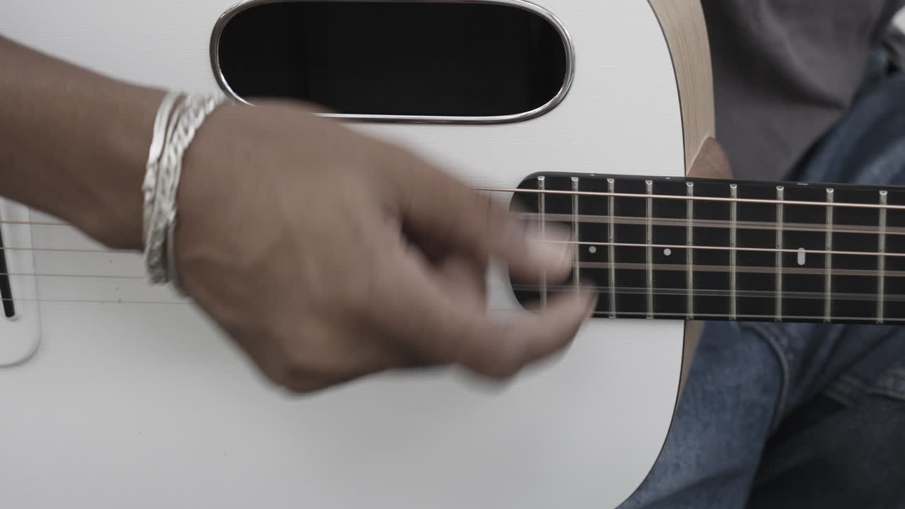 man playing guitar closeup