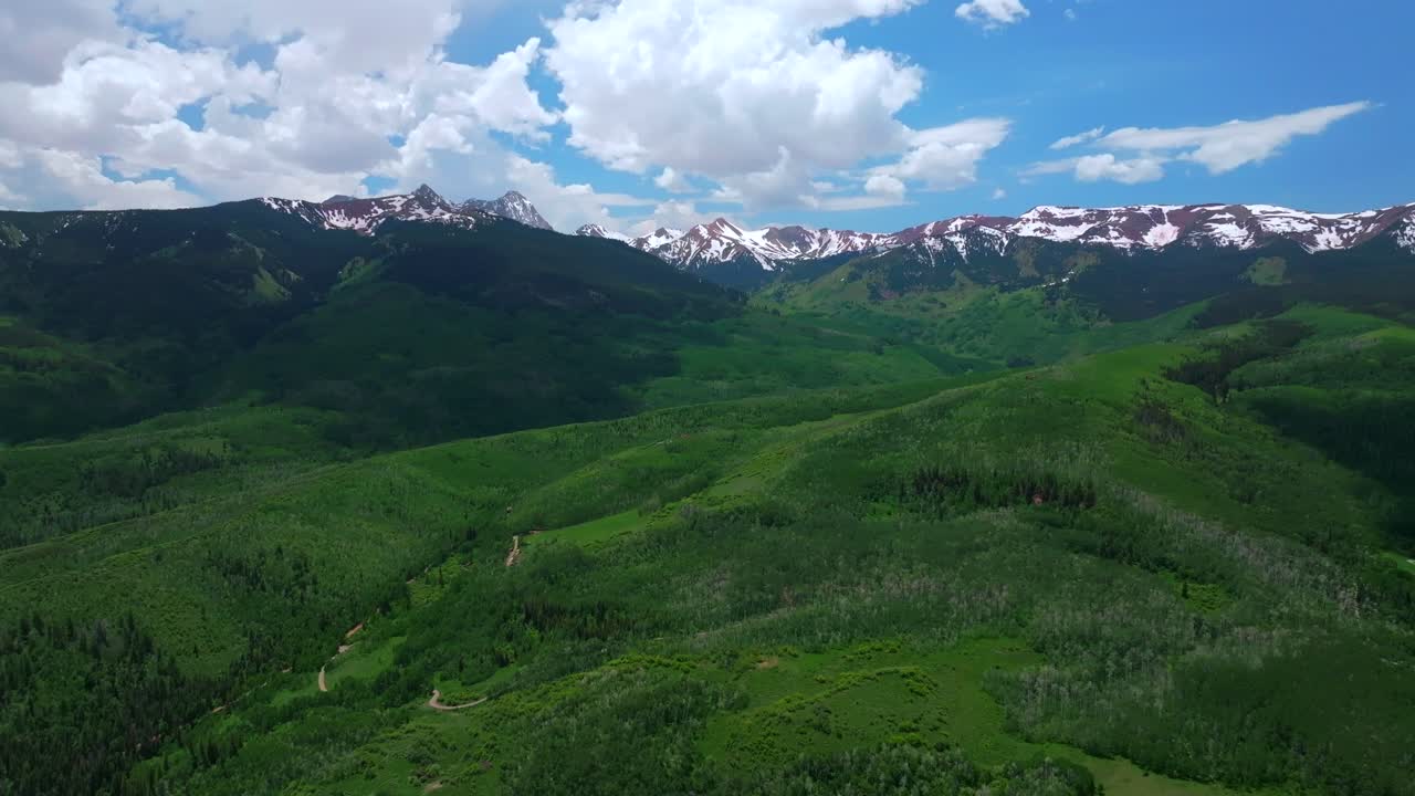 Capitol Peak Wilderness spring summer 14er aerial drone Colorado Aspen Snowmass Elk Rocky Mountains Range Capitol Creek Trailhead Aspen grove White River Forest sunny blue sky forward pan up motion