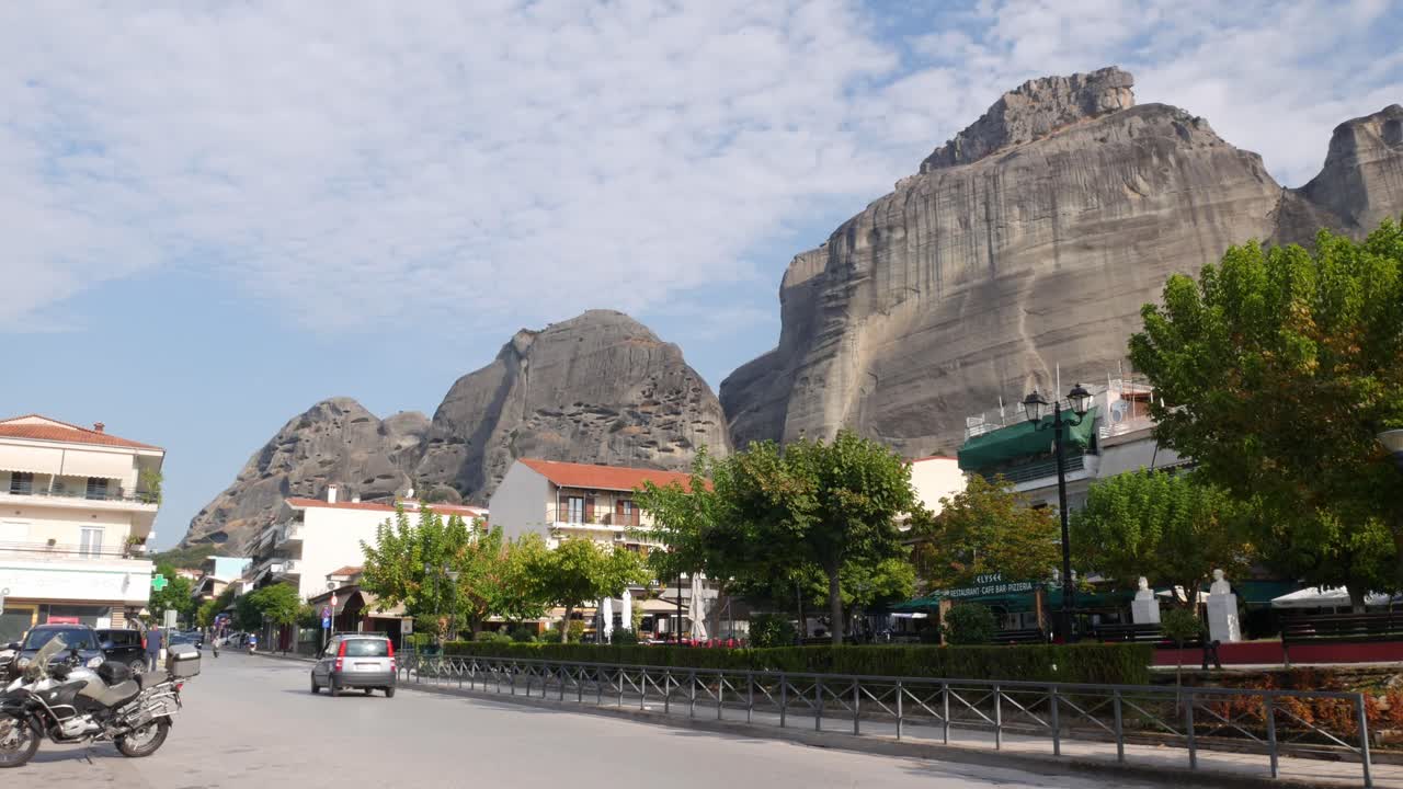 locked shot of the Riga Fereou square with the Meteora mountains in the background