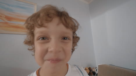 Portrait-of-funny-little-boy-with-curly-hair