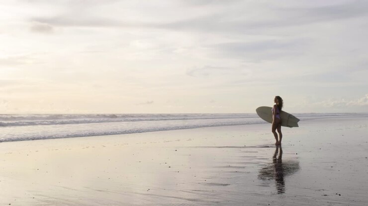 Young woman with surfboard