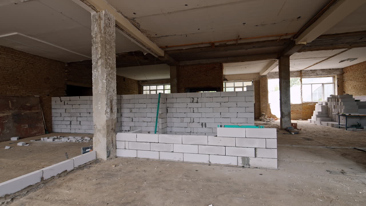 Newly white brick walls in the old premise of the constructed building. Reconstruction of the building in progress.