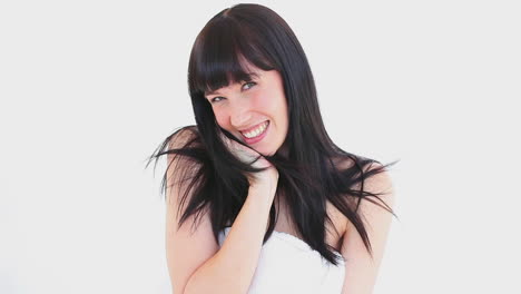 happy brunette woman touching her hair