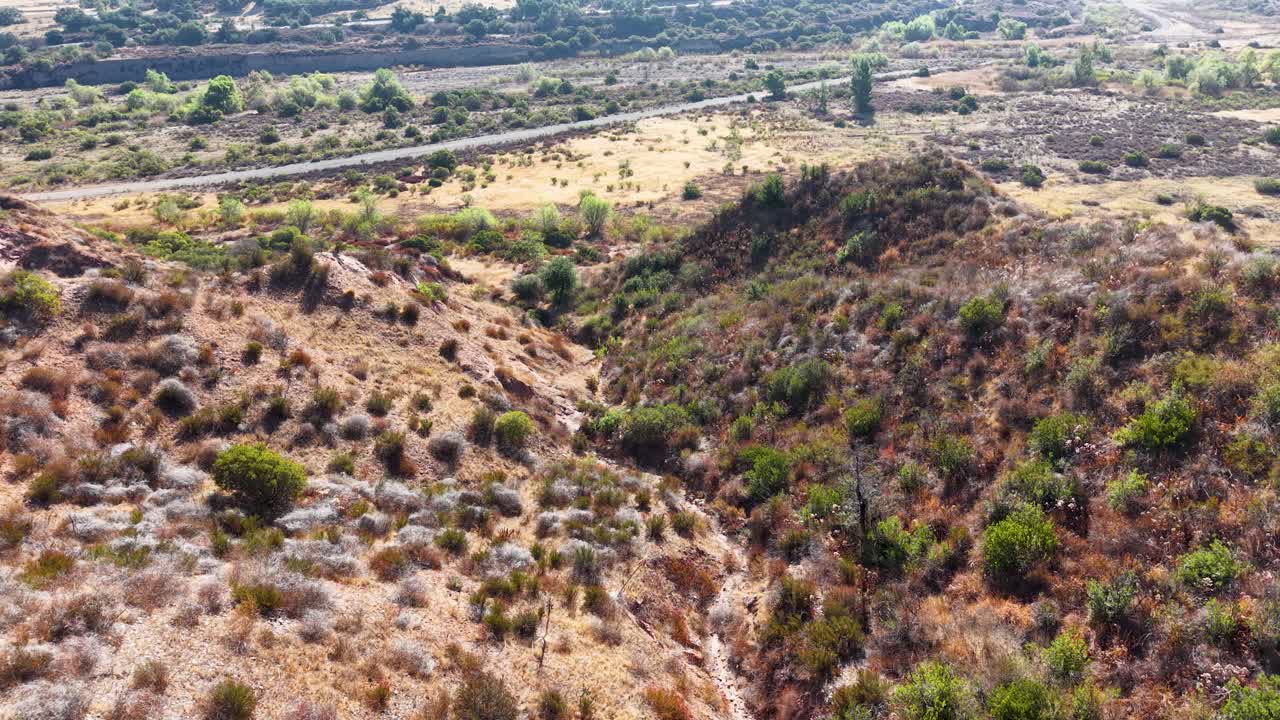 Aerial view of Black Star Canyon Wilderness in California, showing rugged hills, dry brush, and rocky terrain