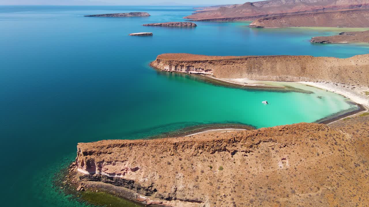 Aerial: yacht moored in tropical bay off Mexico Pacific Ocean coastline, Espirutu Santo Island