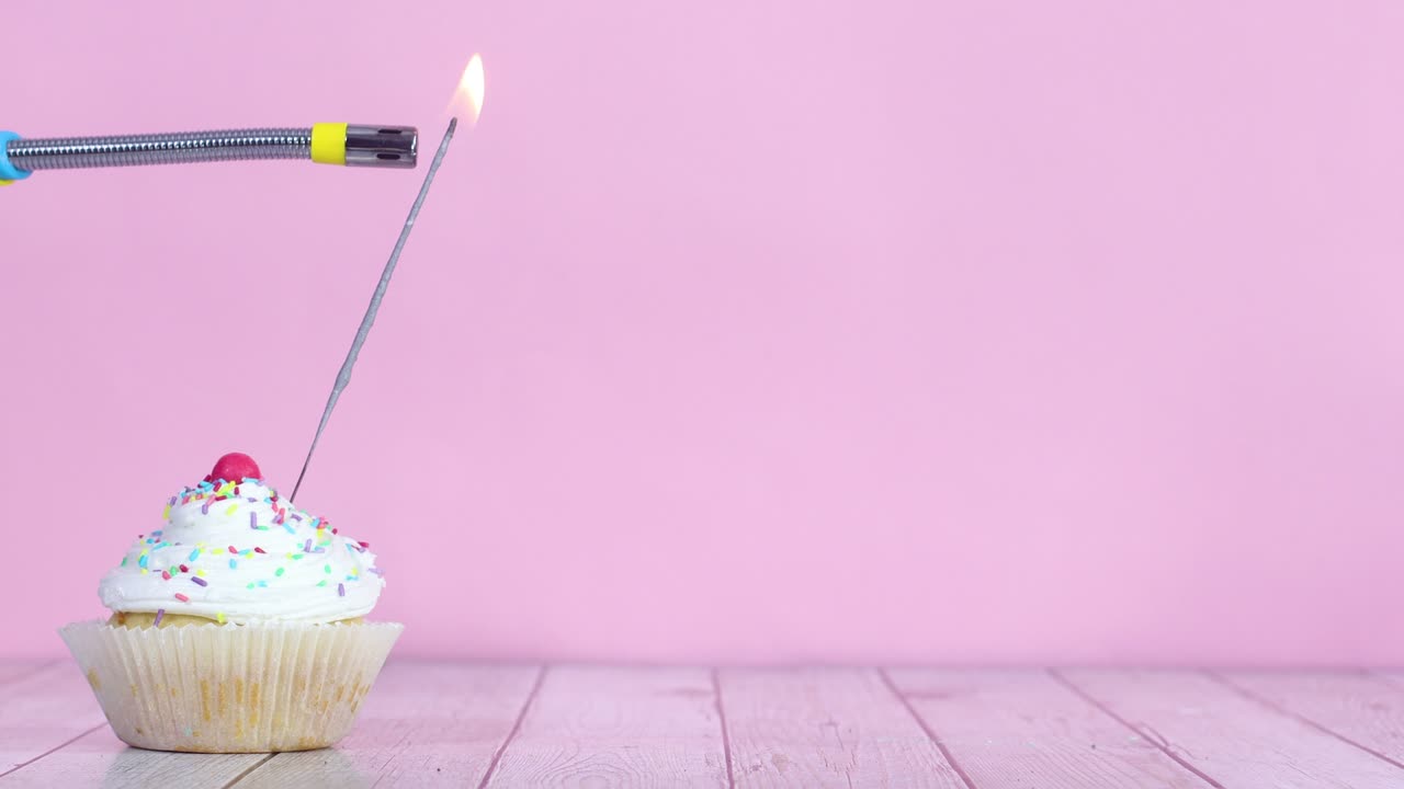 Lighting up fire candle on testy sweet cup cake with white cream