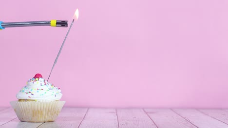 lighting up fire candle on testy sweet cup cake with white cream