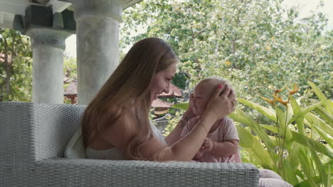 mom playing with toddler on terrace