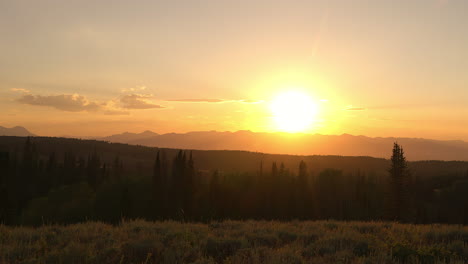 vibrant sky illuminated mountains and forest at sunset