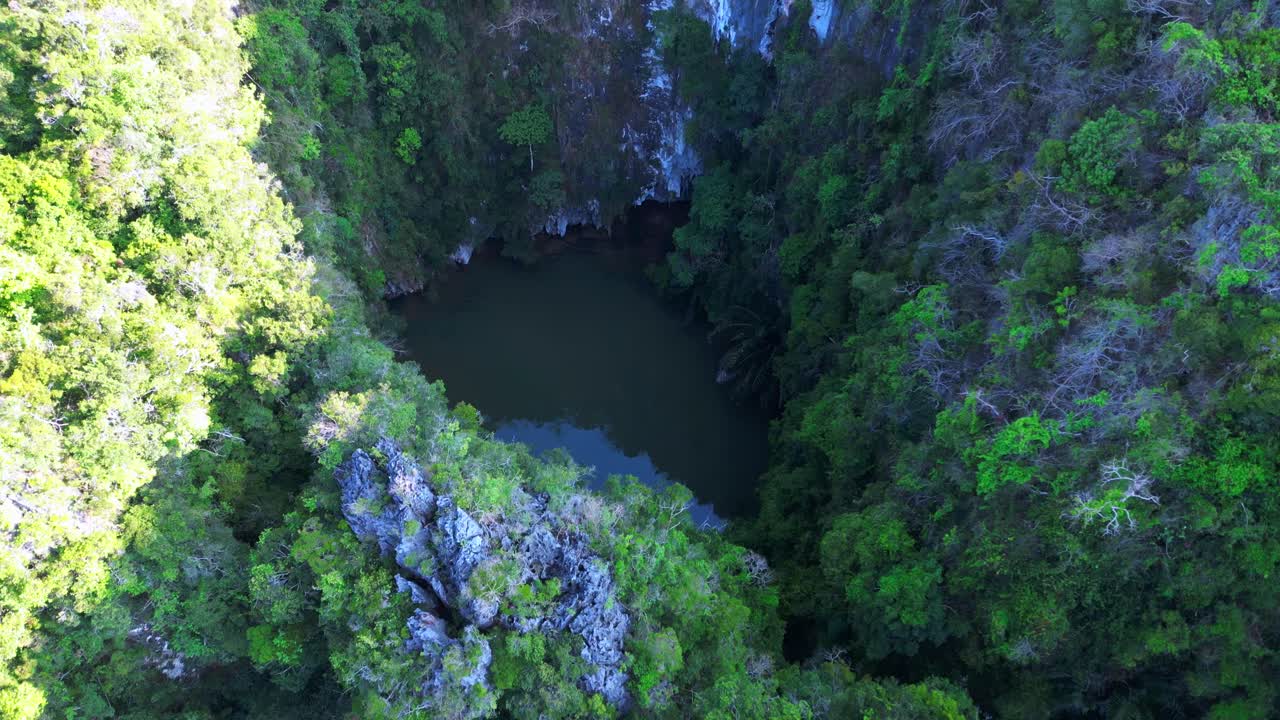 secret lagoon Railay Beach in Krabi, Thailand, featuring limestone cliffs and turquoise water. Smooth aerial view flight