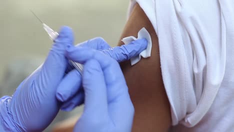 close-up video of a man's arm being injected with the corona virus vaccine