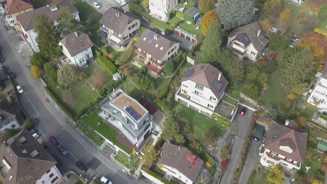 Lausanne town viewed from the top, Houses in a residential neighborhood, a road, gardens and trees in an urban environment, Switzerland, vaud