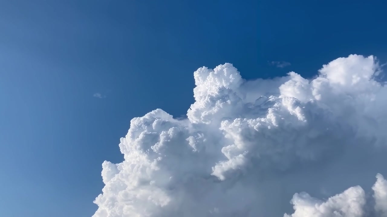 Large White Cumulus Clouds Drifting Across a Clear Blue Sky
