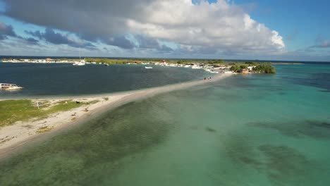 Madrisky isthmus with turquoise waters, lush greenery, and boats moored, aerial view