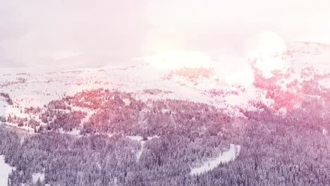 Spots-of-light-and-snow-falling-over-winter-landscape-with-mountains-and-trees