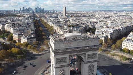 view of the top of the arc de triomphe and views of the city in the background.