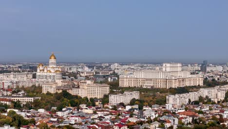 Aerial-View-Over-Bucharest's-Cityscape,-Palace-of-Parliament-And-The-National-Cathedral