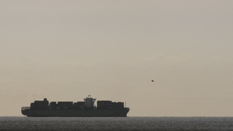 a cargo ship at dawn