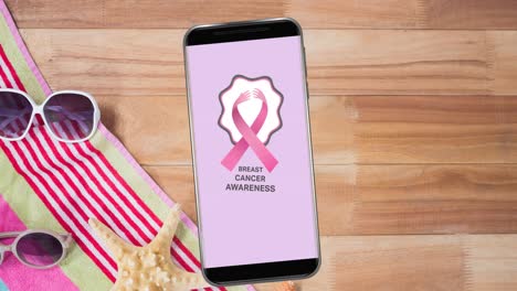 Animación-Del-Logotipo-De-La-Cinta-Rosa-Sobre-El-Cáncer-De-Mama-Con-Texto-Sobre-El-Cáncer-De-Mama-En-La-Pantalla-Del-Teléfono-Inteligente