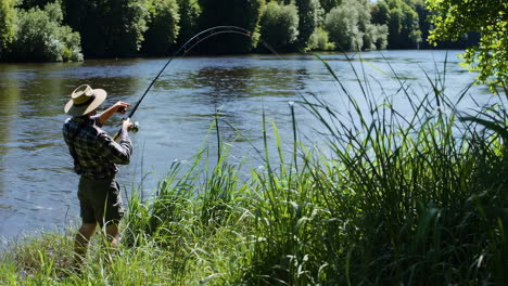 man fishing on a riverbank