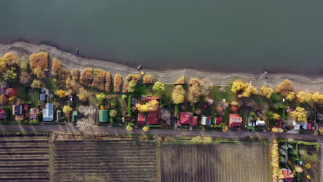 Line-of-houses-at-the-lake-with-beautiful-shadows-on-the-water-because-of-the-sunset