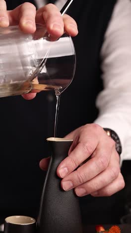 bartender pouring sake