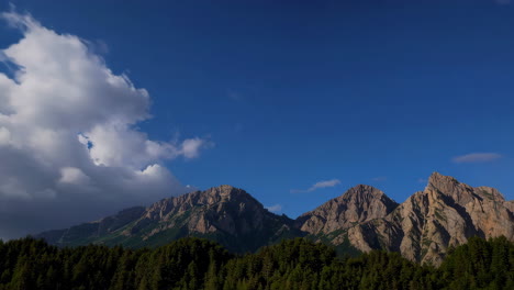 dramatic storm clouds gathering over forested mountains with shafts of light