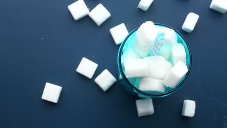 sugar cubes in a turquoise glass