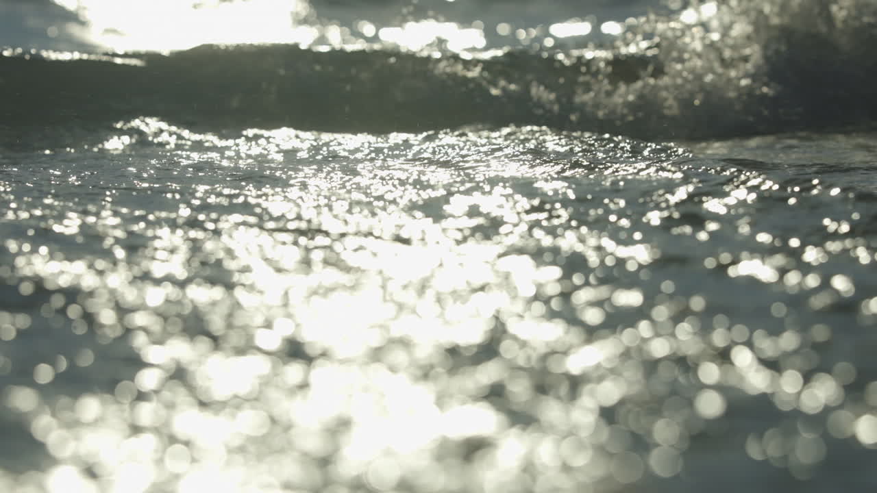 Close-up view of sun reflecting on ocean waves