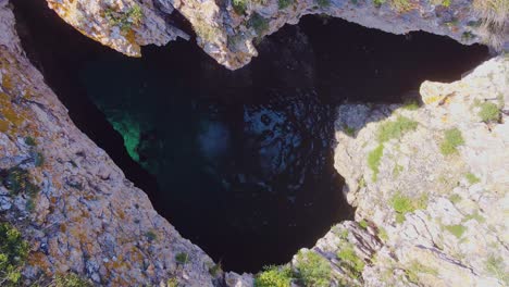 the incredible sight of guys diving from a water cave right into the heart of the ocean